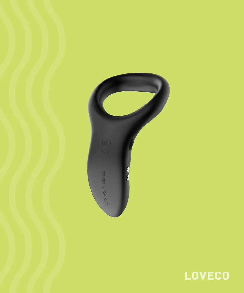Lovense Diamo vibrating silicone penis ring for couples, rechargeable black wearable on lime green background