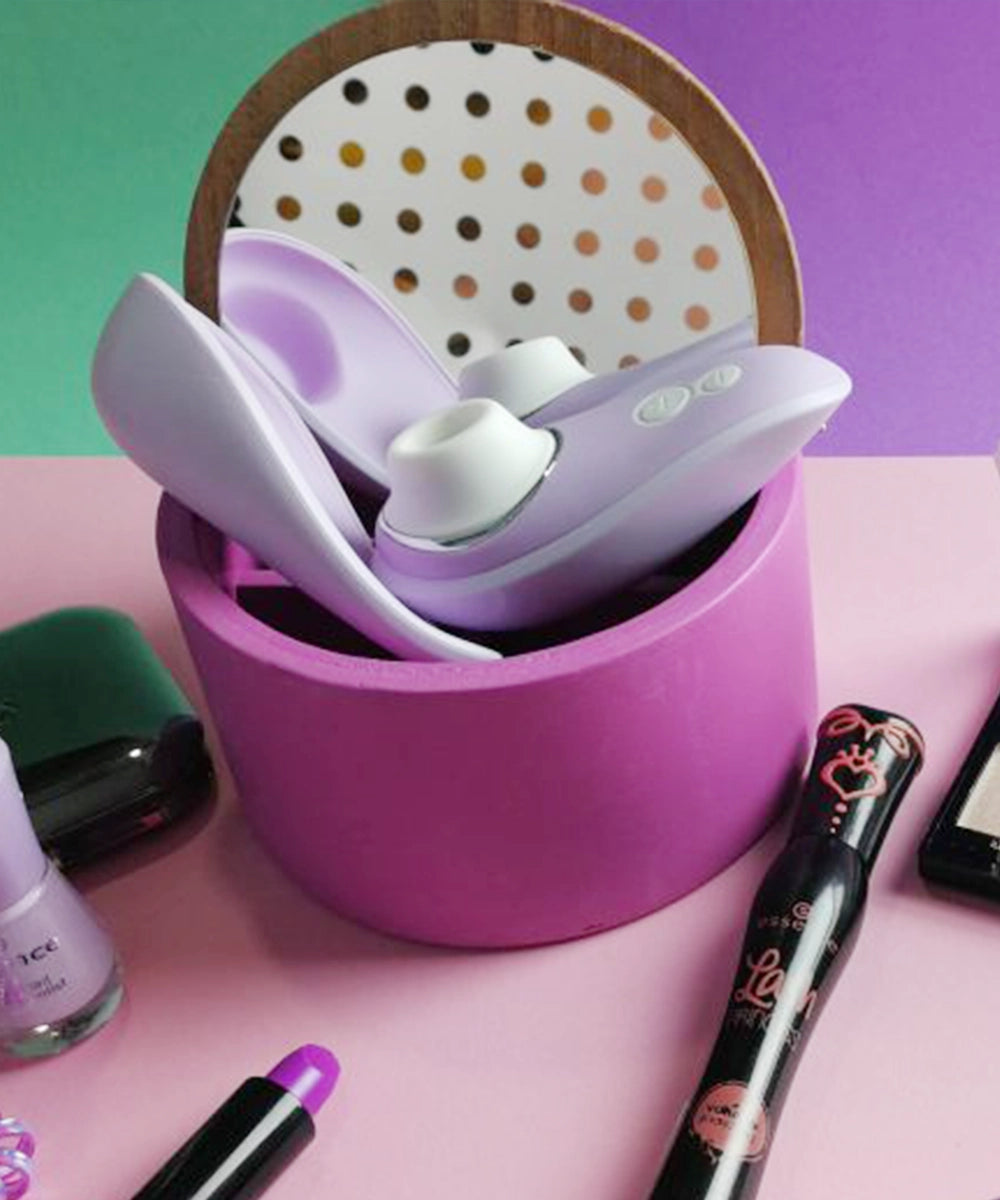 Purple clitoral stimulator with makeup products