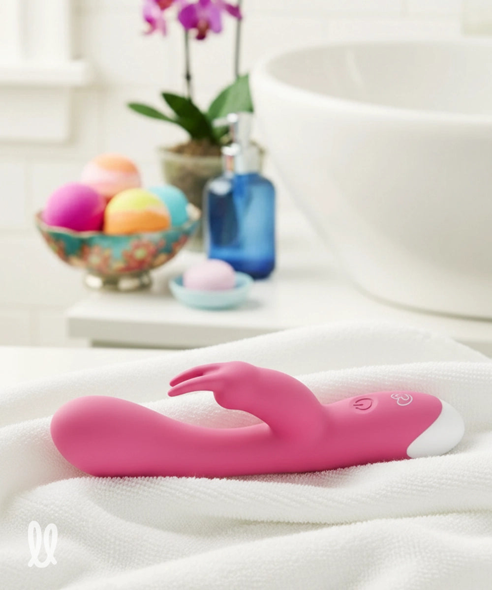 Pink rabbit vibrator on a white towel with a blurred background