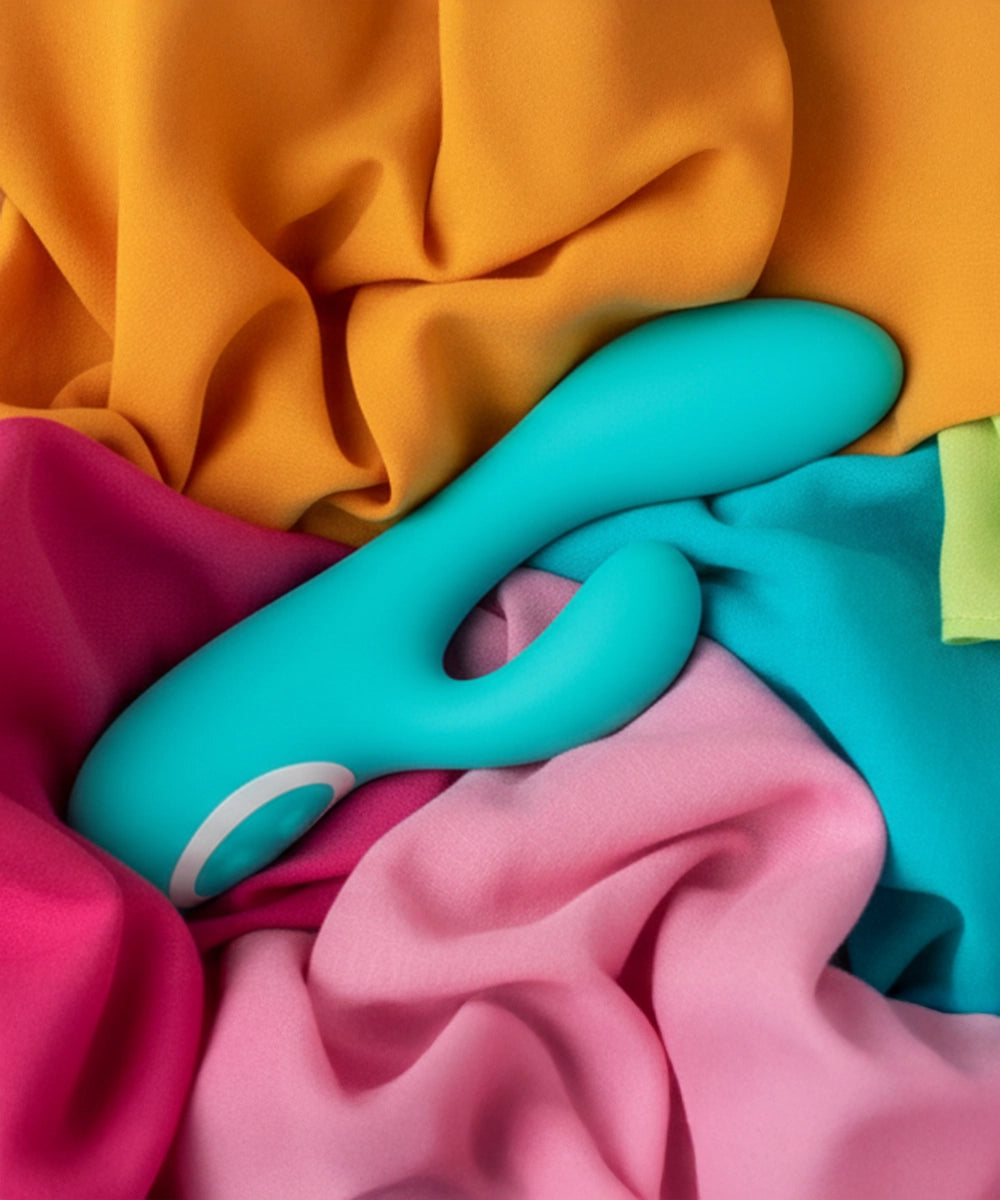 Light blue rabbit vibrator on colorful fabric